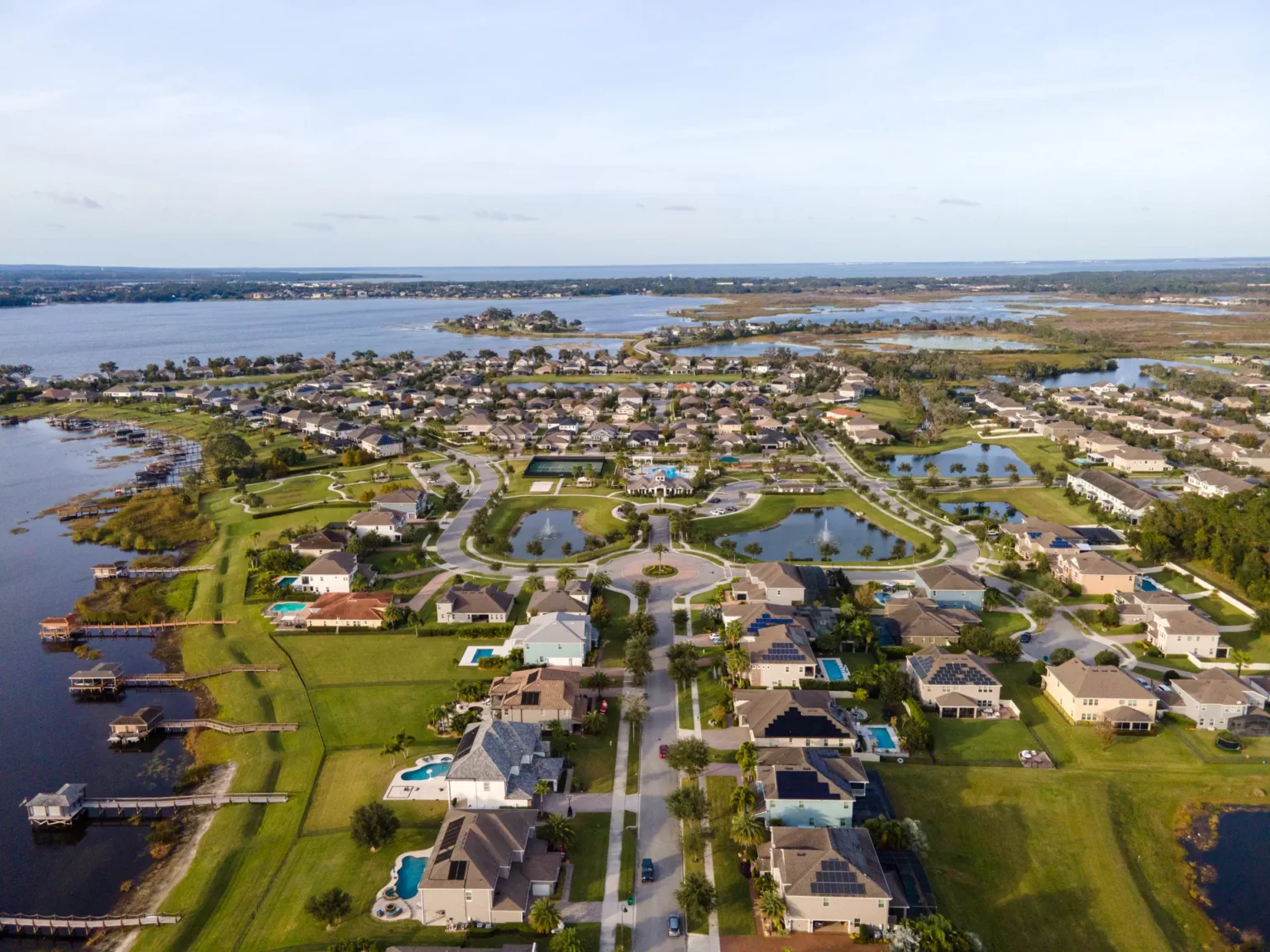 Aerial view of lakefront homes with private docks at Hickory Hammock on Johns Lake