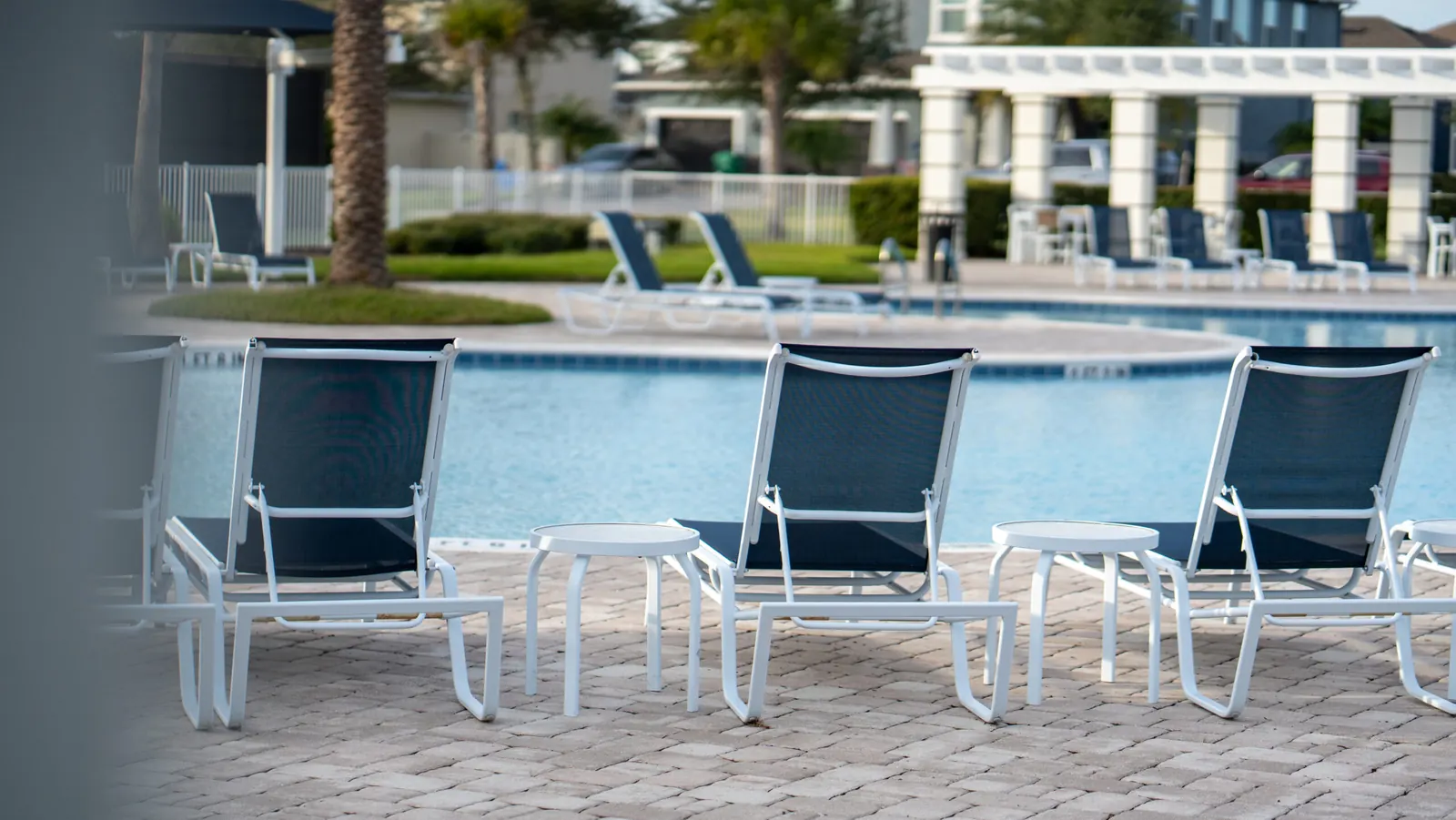 Lounge chairs on the pool deck at the Hickory Hammock clubhouse