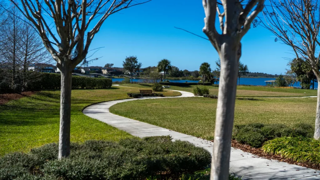 Curving walking path under trees near the lake at Hickory Hammock