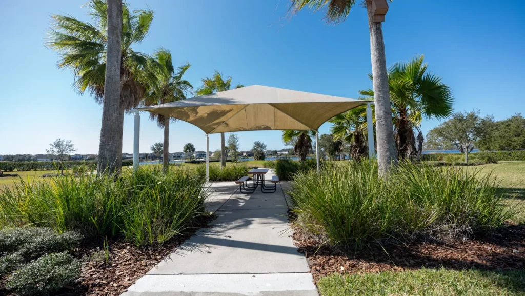 Shade structure and picnic table along a path at Hickory Hammock